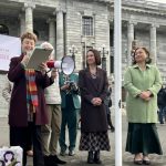 Leonie Morris handing over the stalking law reform petition outside parliament with MPs Ginny Andersen and Marama Davidson
