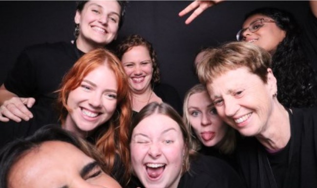 people smiling and posing in a photo booth